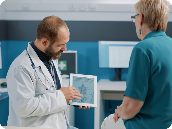 A photo of a real patient and clinician reviewing data together on a tablet or screen.